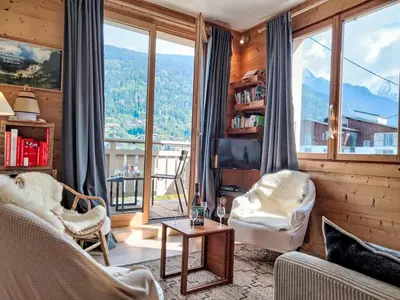 a kitchen with a table with plates on it at Apartment Chalet du Rosay by Interhome in Saint-Gervais-les-Bains