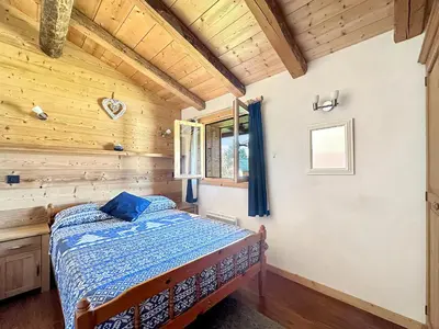 a bedroom with a bed in a wooden room at CH136 - Chalet Kimberley Centre village les Carroz in Les Carroz d'Araches