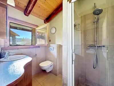 a bathroom with a shower and a toilet and a sink at CH136 - Chalet Kimberley Centre village les Carroz in Les Carroz d'Araches