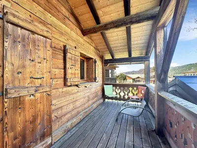 a wooden porch with a bench on a deck at CH136 - Chalet Kimberley Centre village les Carroz in Les Carroz d'Araches