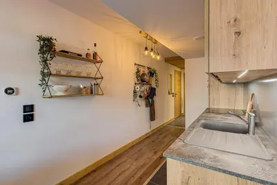 a kitchen with a sink and a counter at Apartment des Alpages - Alpes Travel - Sleeps 6-8 in Les Trabets