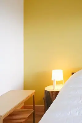 a bedroom with a bed and a lamp on a table at Maison de montagne in Passy