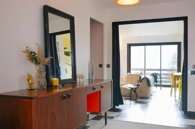 a living room with a wooden dresser with a mirror at Maison de montagne in Passy