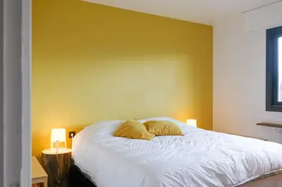 a bedroom with a white bed with two pillows on it at Maison de montagne in Passy