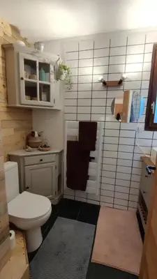 a kitchen with a wooden table with two plates on it at Petit cocon proche Saint Gervais in Saint-Gervais-les-Bains