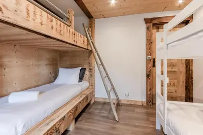 a room with two bunk beds and a ladder at Le Covagnet in Saint-Gervais-les-Bains