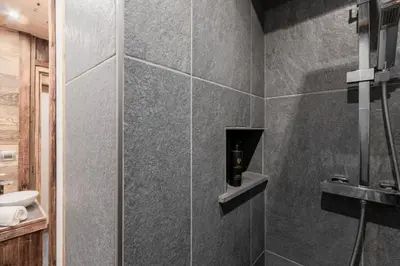 a bathroom with a shower with a soap dispenser at Le Covagnet in Saint-Gervais-les-Bains