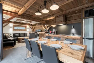 a kitchen and dining room with a wooden table and chairs at Le Covagnet in Saint-Gervais-les-Bains