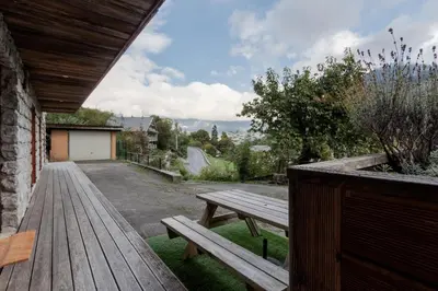 a wooden bench sitting on top of a porch at Le Covagnet in Saint-Gervais-les-Bains