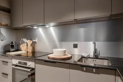 a kitchen with a sink and a counter top at Cristal Des Alpes - Superb T3 - Vue Mont-Blanc in Les Houches