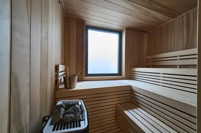 a sauna with a bench and a window at Chalet Choucas - Modern Luxury - Heart of Chamonix in Chamonix-Mont-Blanc