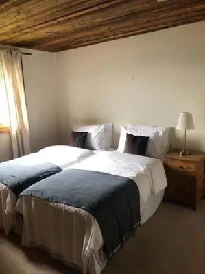 a bedroom with two beds and a window at Chalet Aspre in Samoëns