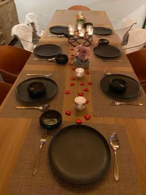 a long table with black plates and silverware on it at Chalet Aspre in Samoëns