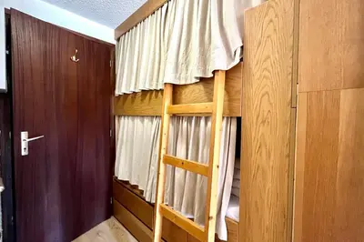 a room with a bunk bed with a window at Terrasse du Front de Neige in Demi-Quartier
