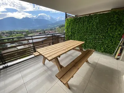 a wooden bench sitting on top of a balcony at Panorama MontBlanc in Domancy