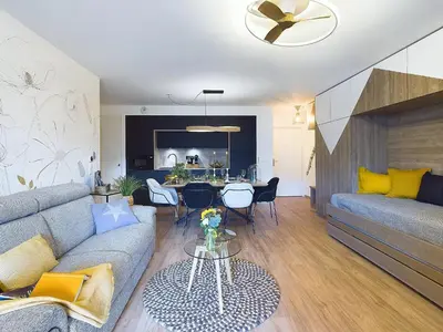 a living room with a couch and a table at Panorama MontBlanc in Domancy