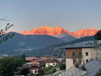 a city with mountains in the background with houses at Panorama MontBlanc in Domancy