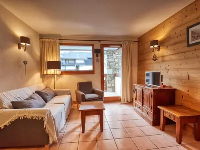 a living room with a couch and a tv at Bel appartement skis aux pieds à Morillon 1100 - 4 à 6 personnes - FR-1-642-94 in Morillon