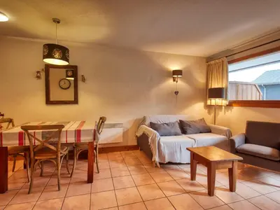 a living room with a couch and a table at Bel appartement skis aux pieds à Morillon 1100 - 4 à 6 personnes - FR-1-642-94 in Morillon