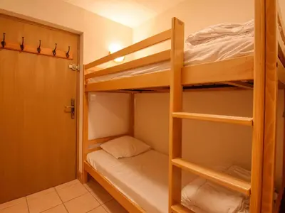 a small room with two bunk beds and a door at Bel appartement skis aux pieds à Morillon 1100 - 4 à 6 personnes - FR-1-642-94 in Morillon