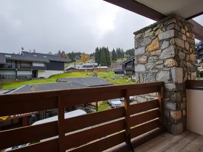 a balcony with a view of a yard at Bel appartement skis aux pieds à Morillon 1100 - 4 à 6 personnes - FR-1-642-94 in Morillon