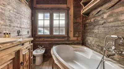 a bathroom with a tub and a toilet and a sink at Ferme des Moussoux in Chamonix-Mont-Blanc