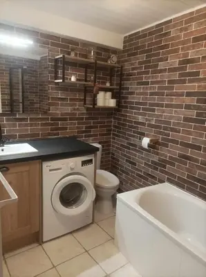 a bathroom with a toilet and a sink and a bath tub at Appartement à la Montagne in Saint-Gervais-les-Bains