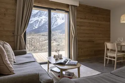 a living room with a view of a mountain at Apartment Léo -Espace bien-être -Piscine in Les Houches