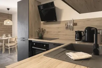 a kitchen with a sink and a counter top at Apartment Léo -Espace bien-être -Piscine in Les Houches