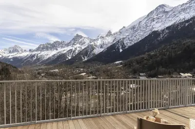 a balcony with a view of a snow covered mountain at Apartment Léo -Espace bien-être -Piscine in Les Houches