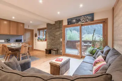 a living room with a couch and a table at Grand Paradis in Chamonix-Mont-Blanc