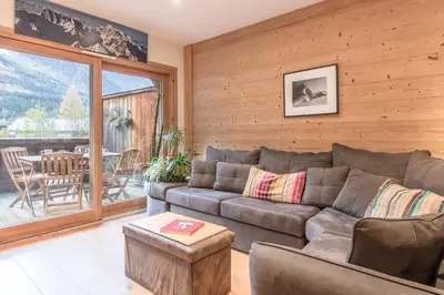 a living room with a couch and a table at Grand Paradis in Chamonix-Mont-Blanc