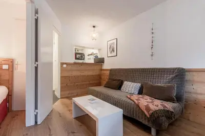 a living room with a couch and a table at Grepon Paradis - Chamonix - Proche Aiguille Midi in Chamonix-Mont-Blanc