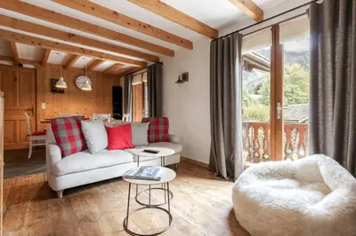 a living room with a couch and a table at La Bastide - Grand chalet privé - Quartier calme in Les Houches