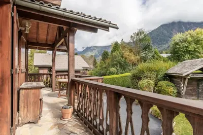 a balcony of a house with a view of the mountains at La Bastide - Grand chalet privé - Quartier calme in Les Houches