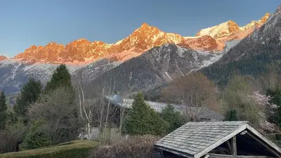 a house in front of a mountain range at La Bastide - Grand chalet privé - Quartier calme in Les Houches