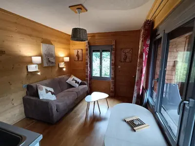 a living room with a couch and a table at La Ferme du Lay in Arâches-la-Frasse