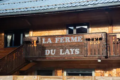 a sign on the side of a wooden building at La Ferme du Lay in Arâches-la-Frasse