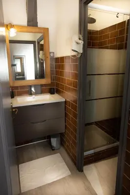a bathroom with a sink and a mirror at La Ferme du Lay in Arâches-la-Frasse