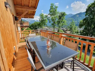 a table on the balcony of a house at Samoens - luxury 4 bedroom top floor apartment with spectacular views in Samoëns