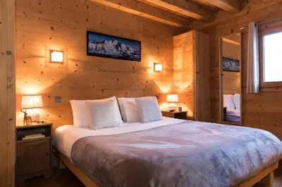 a bedroom with a large bed in a cabin at Chalet Les Drus Luxurious Chalet With Breathtaking Mont Blanc Views From Hot Tub and Garden in Les Houches