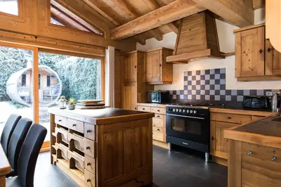 a bedroom with a bed with a lamp on a night stand at Chalet Les Drus Luxurious Chalet With Breathtaking Mont Blanc Views From Hot Tub and Garden in Les Houches