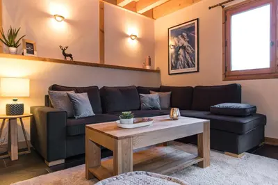 a bedroom with a large bed with wooden walls at Chalet Les Drus Luxurious Chalet With Breathtaking Mont Blanc Views From Hot Tub and Garden in Les Houches