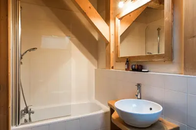 a bathroom with a sink and a bath tub at Chalet Les Drus Luxurious Chalet With Breathtaking Mont Blanc Views From Hot Tub and Garden in Les Houches