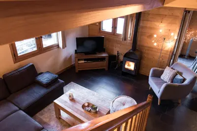 an overhead view of a living room with a fireplace at Chalet Les Drus Luxurious Chalet With Breathtaking Mont Blanc Views From Hot Tub and Garden in Les Houches