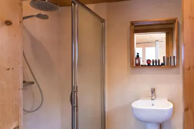 a bathroom with a shower and a sink at Chalet Les Drus Luxurious Chalet With Breathtaking Mont Blanc Views From Hot Tub and Garden in Les Houches