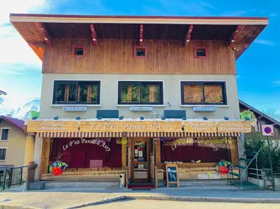 a building with a sign in front of it at Le Chamois d'Assy, résidence alpine de charme in Passy