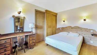 a bedroom with a bed and a dresser and a desk at Chalet Orchidee Megeve sur les pistes in Megève
