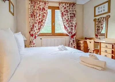 a bedroom with two beds and a window at Chalet Orchidee Megeve sur les pistes in Megève