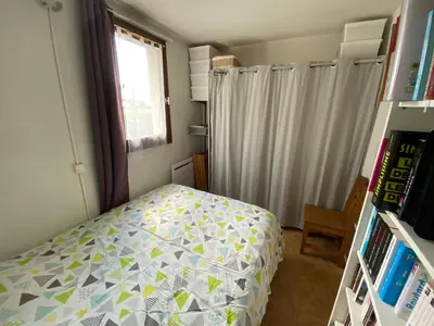a small bedroom with a bed and a window at Samoens centre - appartement une chambre in Samoëns
